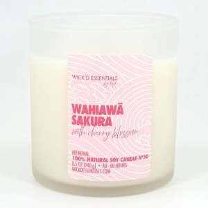 A frosted glass candle jar labeled 'Wahiawā Sakura with Cherry Blossom', made from 100% natural soy wax, 8.5 oz, with a burn time of 40-60 hours.